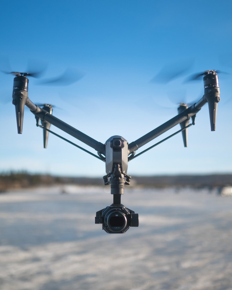 Cinema drone in flight over a snow covered landscape